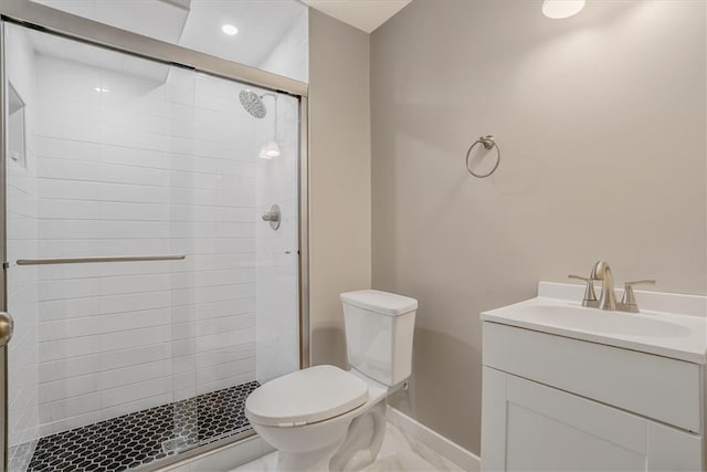 bathroom featuring walk in shower, toilet, and vanity