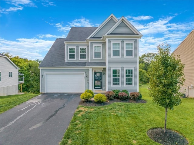 view of front of house with a front lawn and a garage