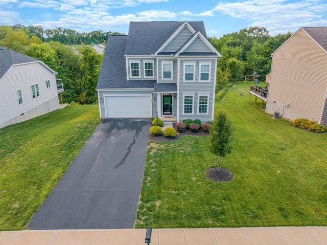 view of front of house with a front lawn and a garage