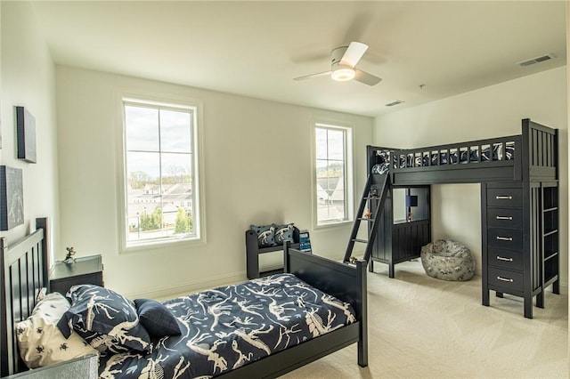 bedroom featuring baseboards, carpet, visible vents, and a ceiling fan