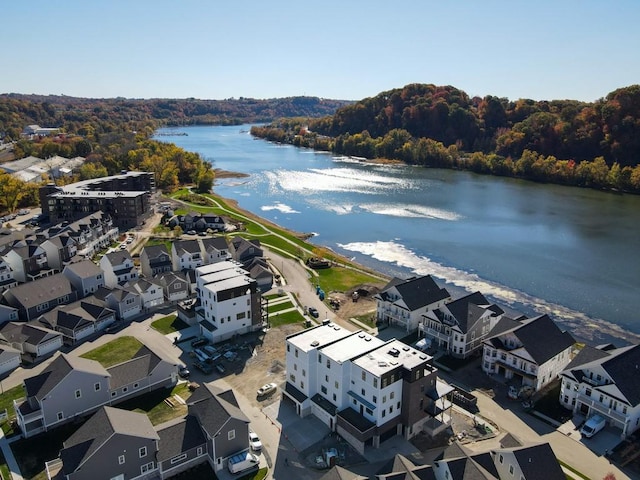 aerial view featuring a water view and a wooded view