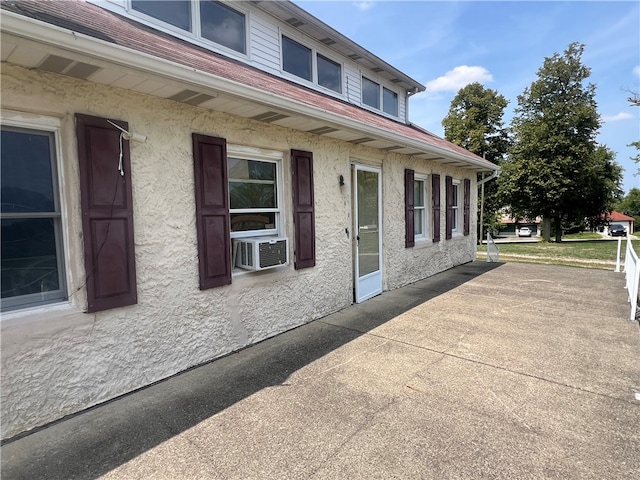 view of side of property with cooling unit