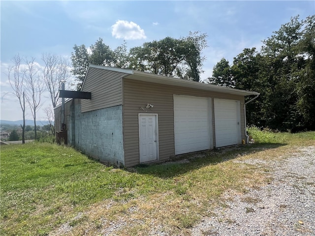 garage featuring a lawn