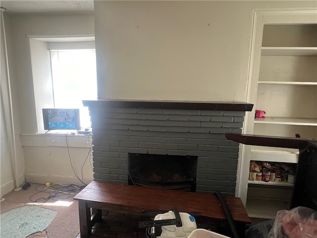 living room with a fireplace and carpet