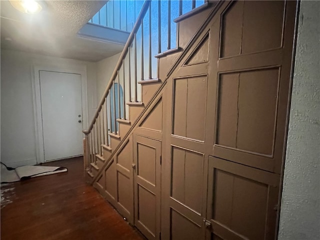 staircase with wood-type flooring