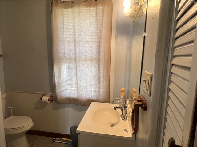 bathroom featuring tile patterned floors, vanity, and toilet