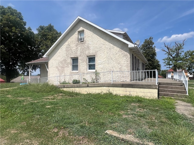 view of side of home with a yard