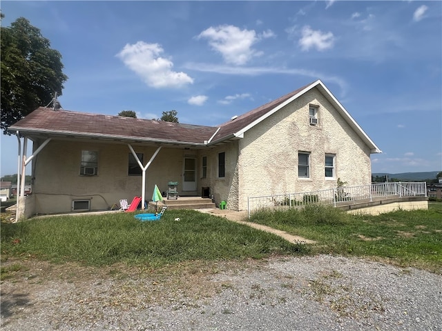 back of property featuring cooling unit