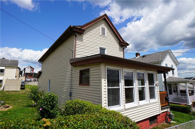 view of side of home featuring a lawn