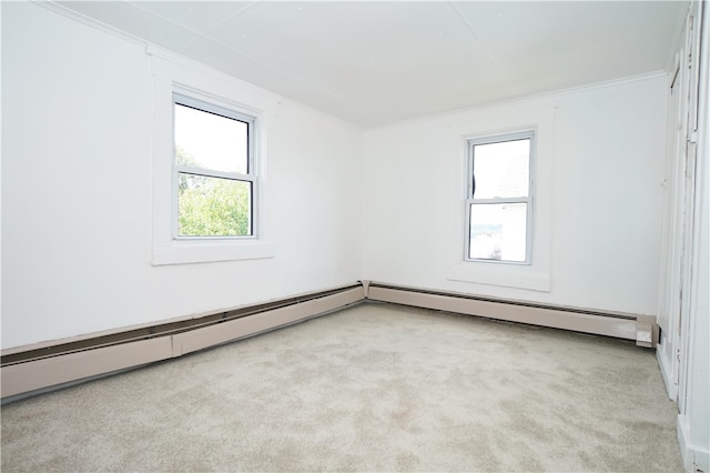 carpeted empty room featuring a healthy amount of sunlight, a baseboard radiator, and ornamental molding