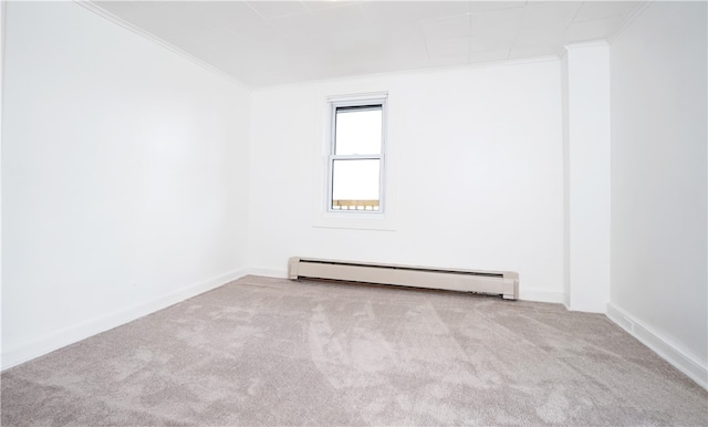 spare room featuring baseboard heating, crown molding, and light carpet