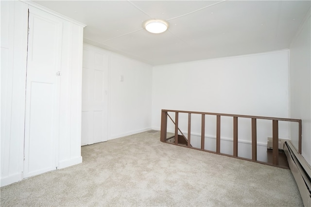 empty room featuring light carpet and a baseboard radiator