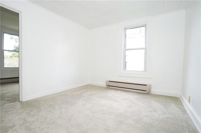 spare room with light carpet, a baseboard radiator, and ornamental molding