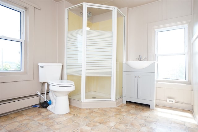 bathroom featuring vanity, a wealth of natural light, and a shower with shower door