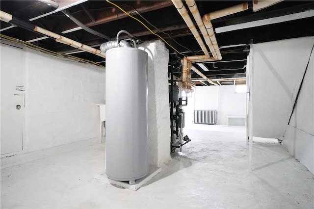 basement featuring radiator heating unit and gas water heater