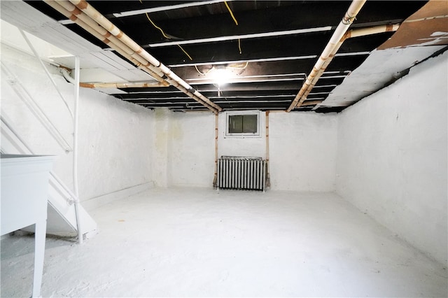 basement featuring radiator heating unit