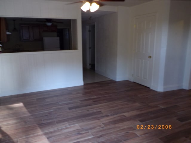 unfurnished living room with wood-type flooring and ceiling fan