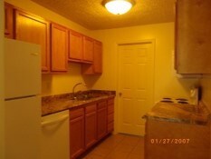 kitchen featuring white refrigerator, sink, and light tile patterned floors