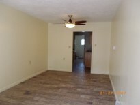 empty room with ceiling fan and hardwood / wood-style floors