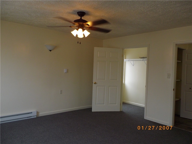 unfurnished bedroom with baseboard heating, a textured ceiling, carpet, a closet, and ceiling fan