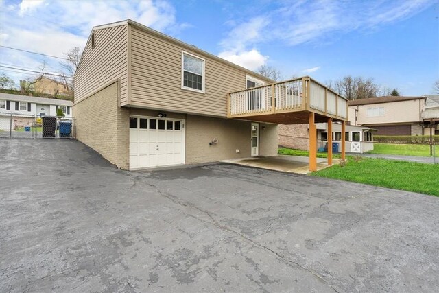 view of front facade with a deck and a garage