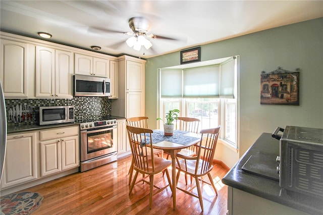 kitchen with tasteful backsplash, ceiling fan, stainless steel appliances, and light hardwood / wood-style floors