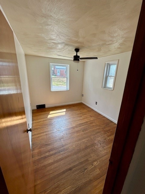 unfurnished room featuring ceiling fan and hardwood / wood-style flooring