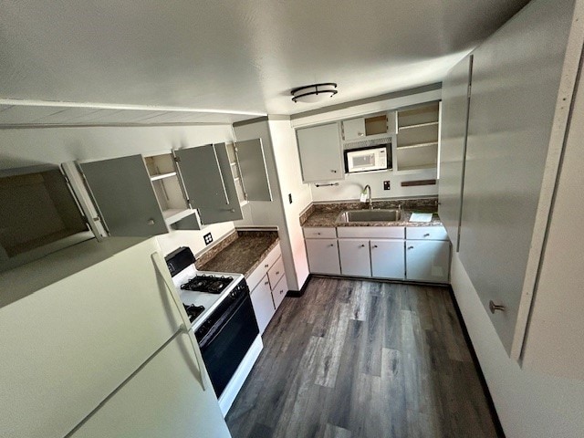 kitchen with dark wood-type flooring, sink, and white appliances