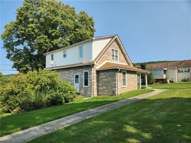 view of side of property with a yard