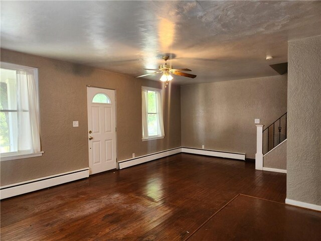 entryway featuring baseboard heating, dark hardwood / wood-style floors, and ceiling fan