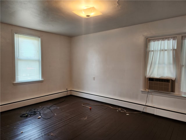 spare room with a baseboard heating unit, cooling unit, and dark hardwood / wood-style flooring