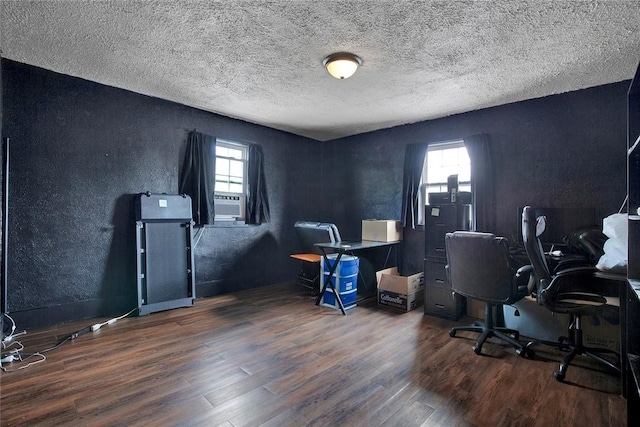 office space with dark wood-style floors, a textured wall, and a textured ceiling