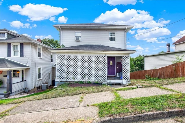 view of front of home with fence and central AC unit