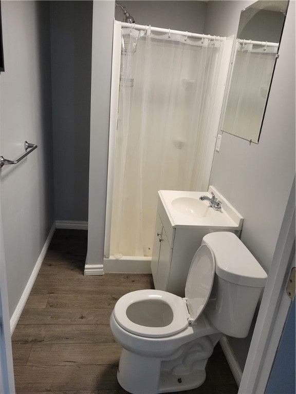 bathroom featuring vanity, toilet, and hardwood / wood-style floors