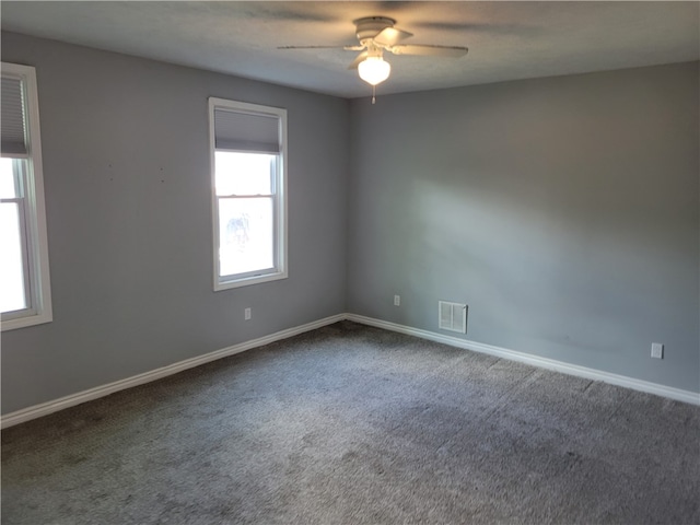 spare room with ceiling fan and carpet