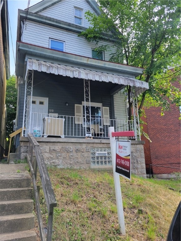 view of front facade with a porch and a garage