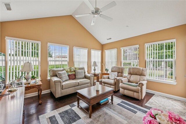 interior space with ceiling fan, high vaulted ceiling, dark hardwood / wood-style flooring, and a wealth of natural light