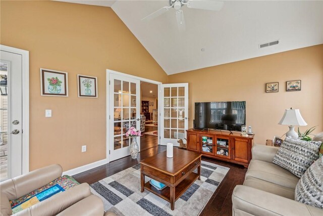 living room with ceiling fan, dark hardwood / wood-style floors, high vaulted ceiling, and french doors