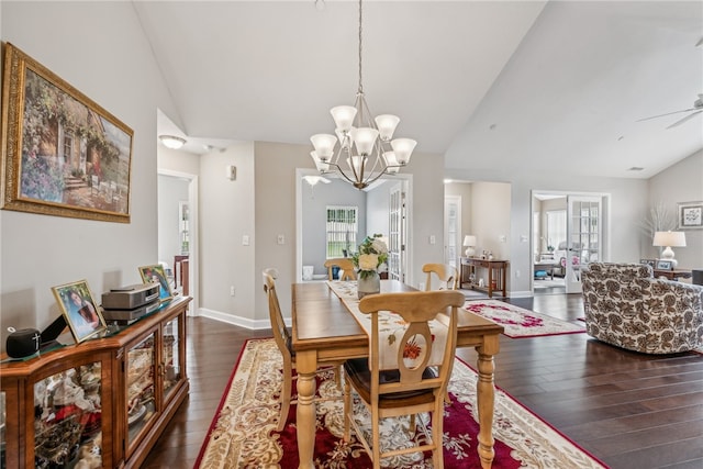 dining room featuring lofted ceiling, dark wood-type flooring, and ceiling fan with notable chandelier