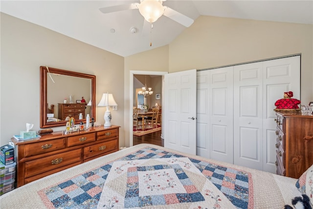 bedroom featuring ceiling fan with notable chandelier, lofted ceiling, a closet, and wood-type flooring