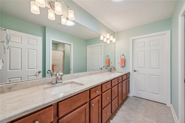 bathroom featuring a notable chandelier, tile patterned floors, and double vanity