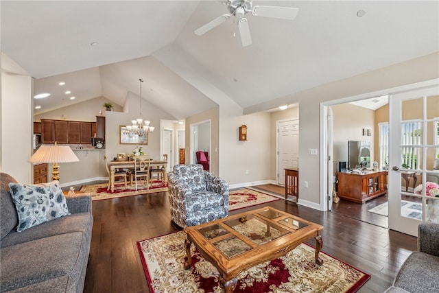 living room featuring ceiling fan with notable chandelier, dark wood-type flooring, and high vaulted ceiling