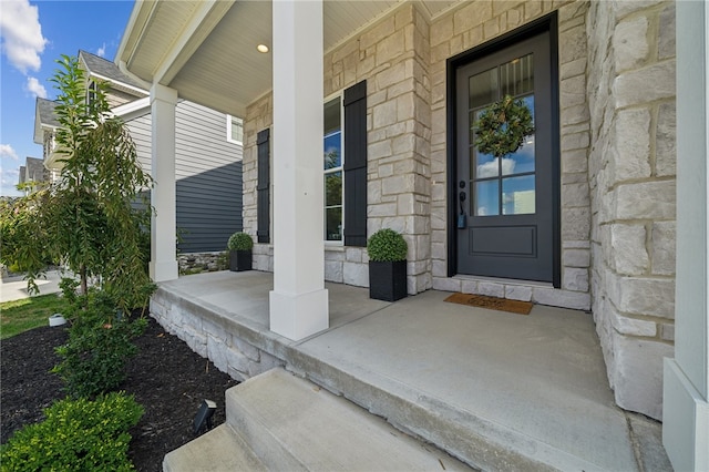 view of exterior entry with a porch