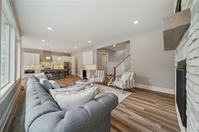 living room featuring light hardwood / wood-style floors and a fireplace