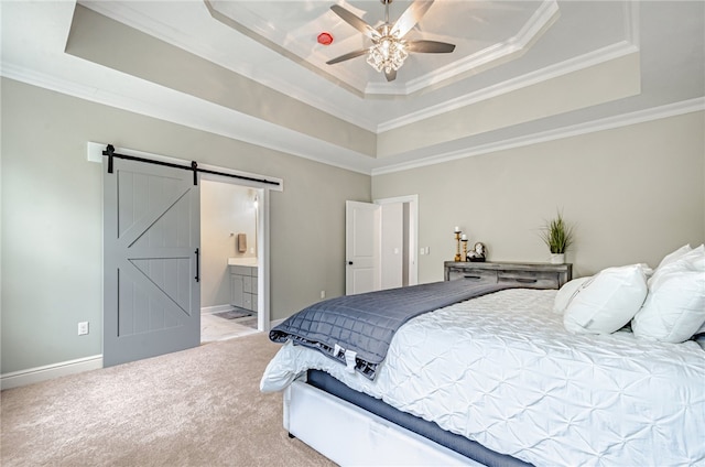 carpeted bedroom featuring ceiling fan, a raised ceiling, crown molding, and a barn door