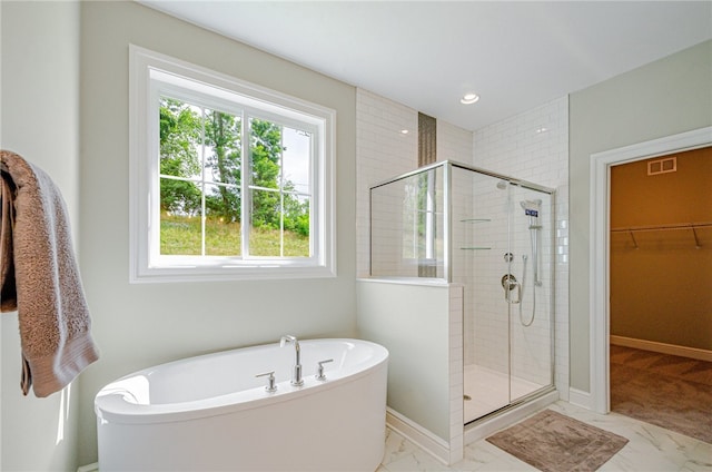 bathroom with tile patterned flooring, plenty of natural light, and shower with separate bathtub