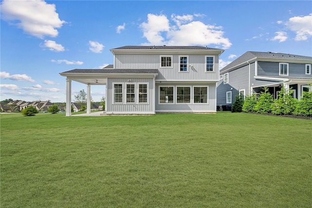 back of house featuring a lawn