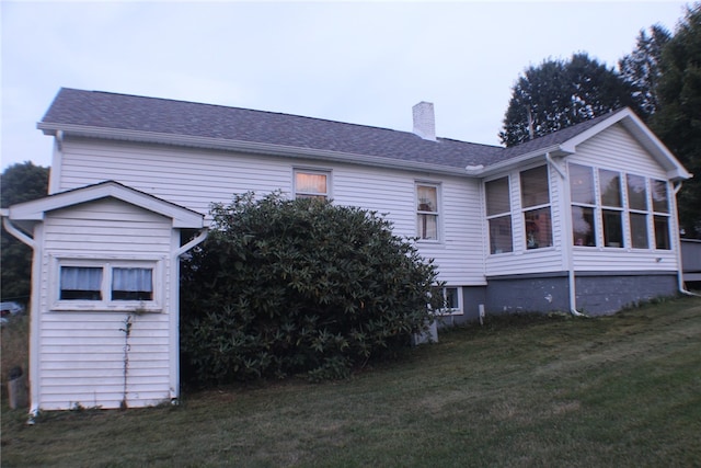 exterior space featuring a lawn and a sunroom