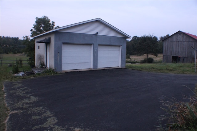 view of garage at dusk