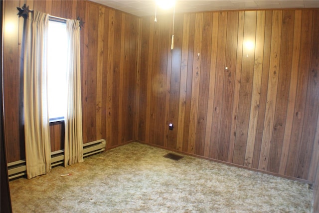 carpeted spare room featuring wooden walls